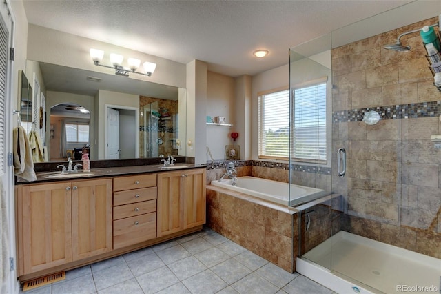 1995 E 166th Ave, Thornton, CO 80602 - bathroom featuring a stall shower, a garden tub, double vanity, and tile patterned flooring