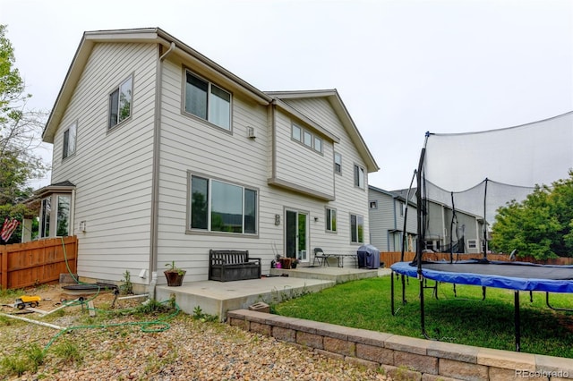 1995 E 166th Ave, Thornton, CO 80602 - rear view of house with a trampoline and a patio