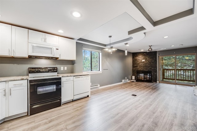 kitchen featuring a ceiling fan, a large fireplace, white cabinets, light wood-type flooring, and white appliances