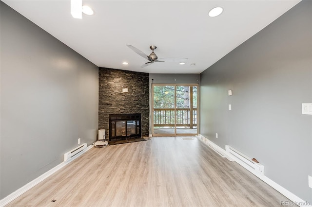 unfurnished living room featuring baseboards, a baseboard radiator, wood finished floors, baseboard heating, and a fireplace