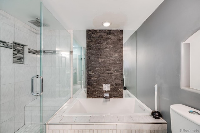 bathroom featuring a garden tub, a shower stall, and toilet