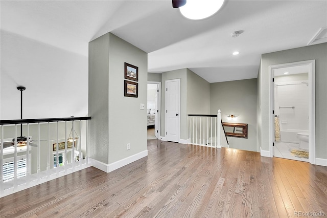 empty room featuring a ceiling fan, baseboards, recessed lighting, and wood finished floors