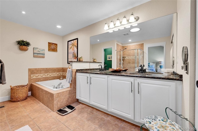 bathroom featuring a garden tub, a stall shower, vanity, tile patterned floors, and recessed lighting
