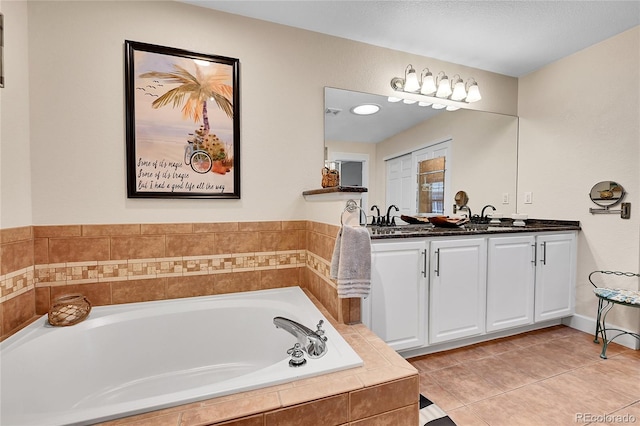 full bathroom with double vanity, a sink, a bath, and tile patterned floors