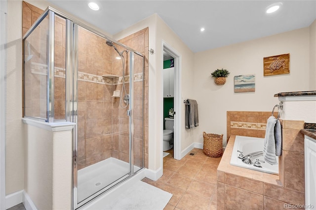 bathroom featuring a bath, tile patterned flooring, a stall shower, baseboards, and toilet