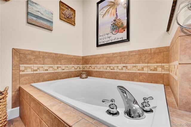 bathroom featuring a garden tub and tile patterned floors