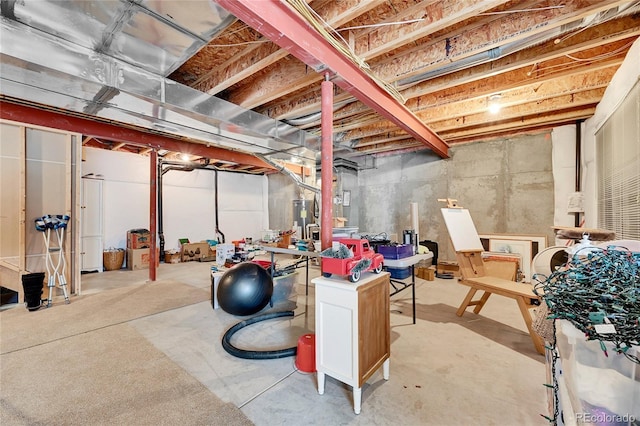 unfinished basement featuring water heater