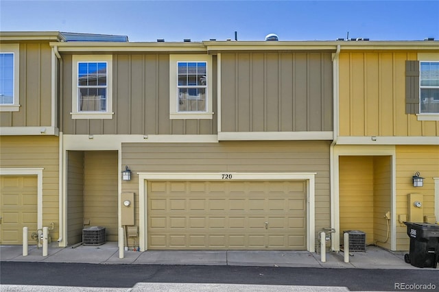 multi unit property with board and batten siding, central AC, and a garage