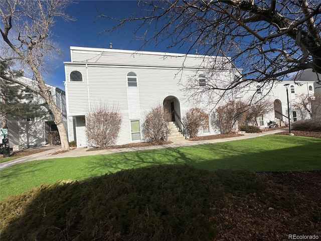 back of property featuring a lawn