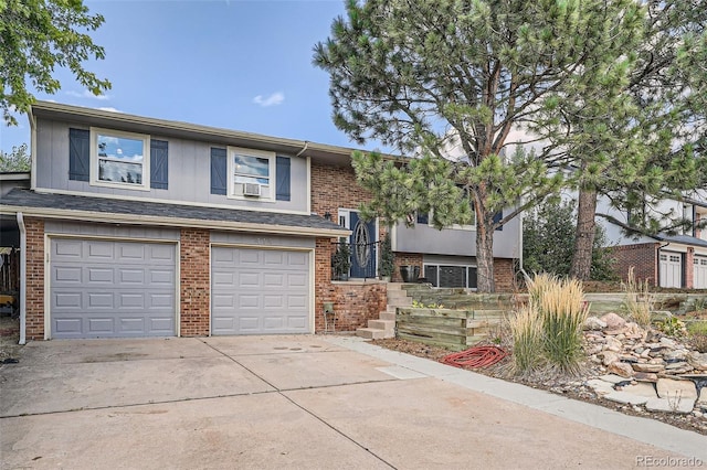 split foyer home featuring cooling unit and a garage