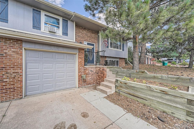 view of front of home featuring cooling unit and a garage