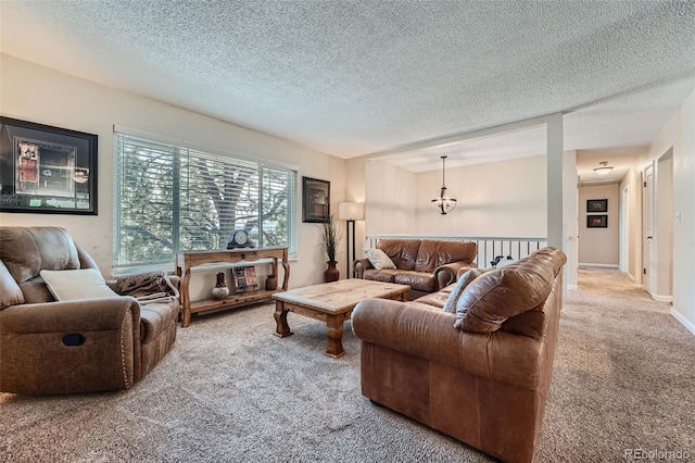 living room with a textured ceiling and carpet