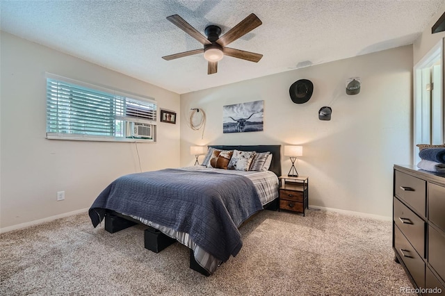 bedroom with ceiling fan, cooling unit, a textured ceiling, and light carpet