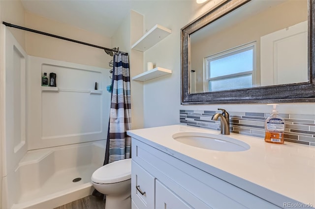 bathroom featuring vanity, tasteful backsplash, curtained shower, wood-type flooring, and toilet