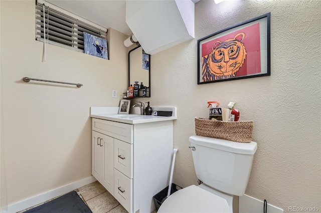 bathroom with vanity, toilet, and tile patterned floors