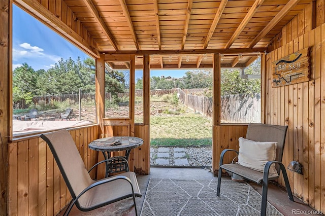 sunroom featuring wood ceiling and beam ceiling