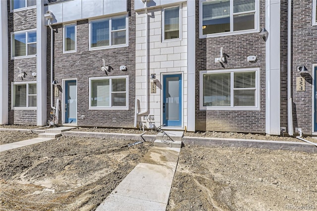 property entrance with brick siding