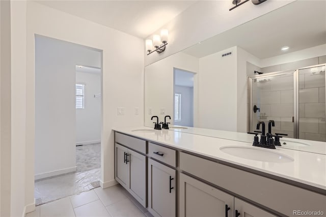 full bath with double vanity, a sink, and visible vents