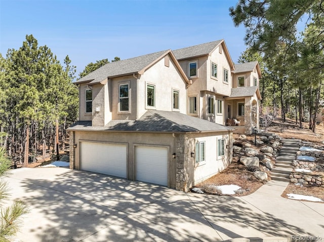 view of front of home featuring a garage, a shingled roof, stairs, concrete driveway, and stucco siding