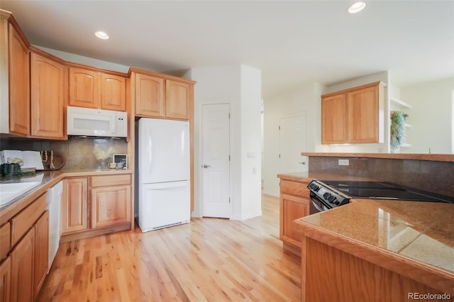 kitchen with light wood finished floors, white appliances, recessed lighting, and decorative backsplash