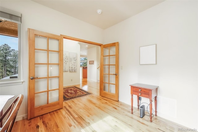 doorway featuring french doors, visible vents, and wood finished floors