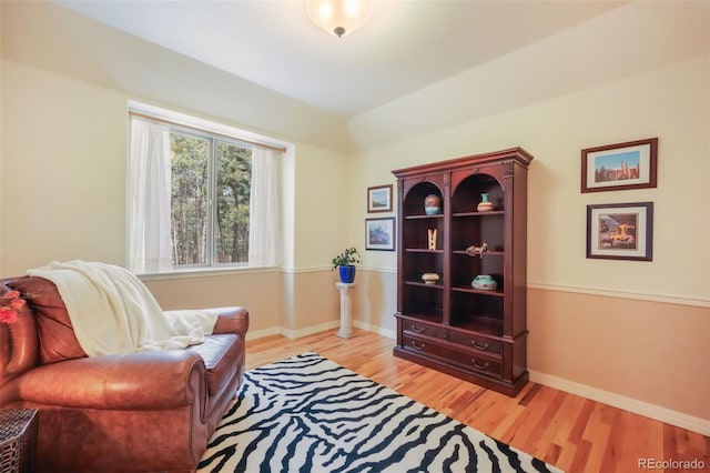 sitting room featuring baseboards and light wood-style floors