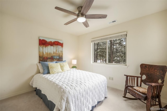 carpeted bedroom with ceiling fan, visible vents, and baseboards