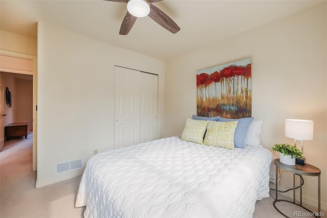 bedroom with baseboards, visible vents, a ceiling fan, carpet flooring, and a closet