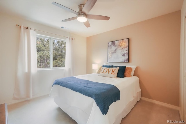 carpeted bedroom with baseboards, visible vents, and a ceiling fan