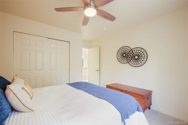 carpeted bedroom featuring ceiling fan and a closet