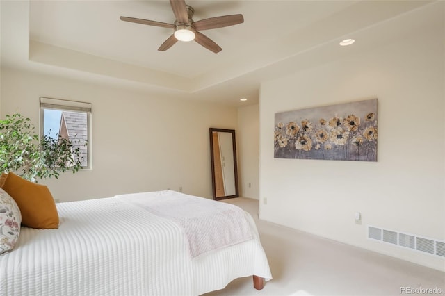 bedroom with recessed lighting, a raised ceiling, visible vents, and light colored carpet