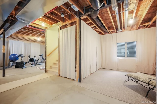 unfinished basement featuring stairway