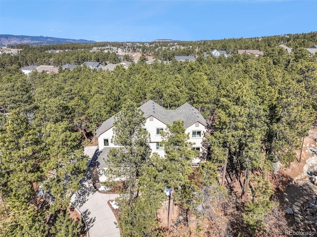 birds eye view of property with a forest view