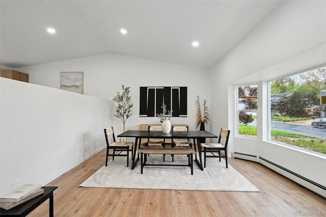 dining room featuring baseboard heating, lofted ceiling, light wood-style floors, recessed lighting, and baseboards