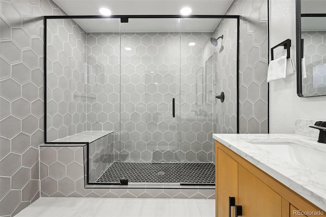 bathroom featuring vanity, a shower stall, and recessed lighting