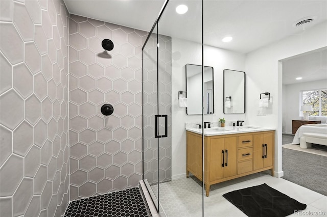 full bathroom featuring ensuite bathroom, recessed lighting, a shower stall, double vanity, and baseboards