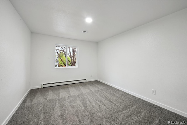 carpeted spare room with a baseboard heating unit and baseboards