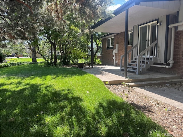 11351 Quivas Way, Denver, CO 80234 - view of green lawn with entry steps and a patio area