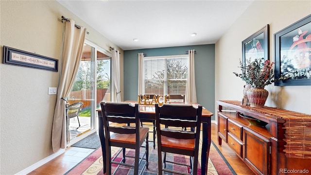 dining room with baseboards and wood finished floors