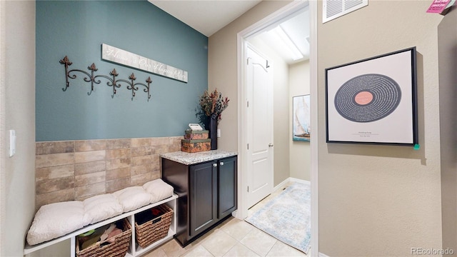 mudroom with light tile patterned flooring and visible vents