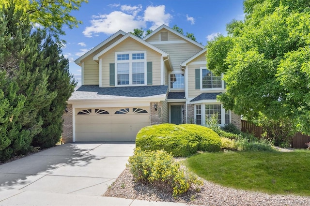 9823 Salford Ln, Highlands Ranch, CO 80126 - view of front of property with brick siding, an attached garage, and concrete driveway