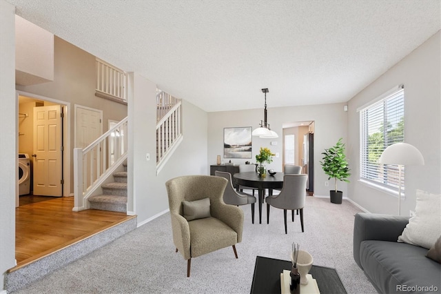 9823 Salford Ln, Highlands Ranch, CO 80126 - living room featuring carpet flooring, washer / clothes dryer, stairs, and a textured ceiling