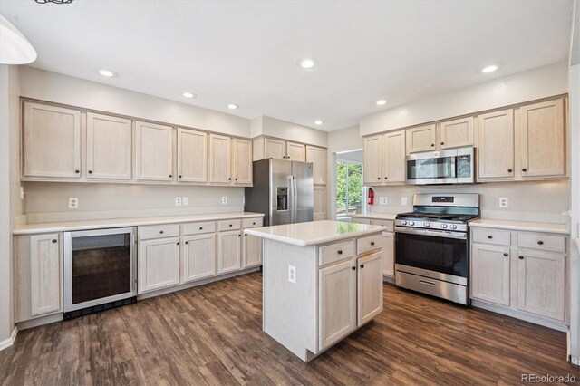 9823 Salford Ln, Highlands Ranch, CO 80126 - kitchen featuring appliances with stainless steel finishes, beverage cooler, light countertops, dark wood-style floors, and a kitchen island