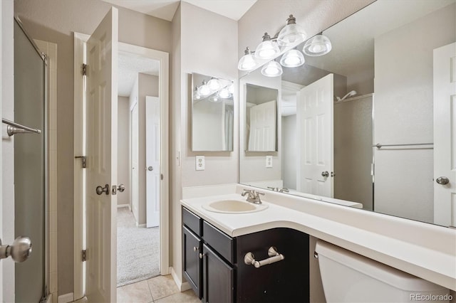 9823 Salford Ln, Highlands Ranch, CO 80126 - full bath featuring tile patterned floors, an enclosed shower, and vanity