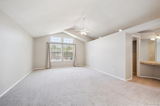 9823 Salford Ln, Highlands Ranch, CO 80126 - empty room with a ceiling fan, carpet floors, a textured ceiling, and vaulted ceiling