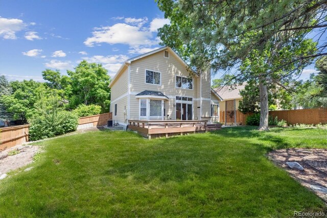 9823 Salford Ln, Highlands Ranch, CO 80126 - rear view of house with a wooden deck and a fenced backyard
