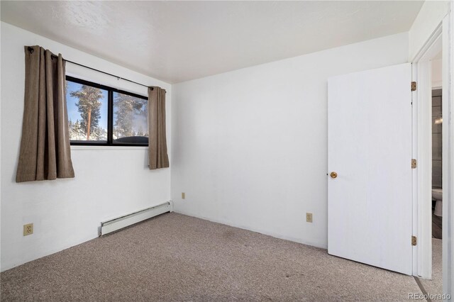 empty room with a baseboard radiator and light colored carpet