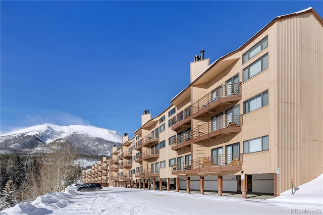 snow covered property with a mountain view