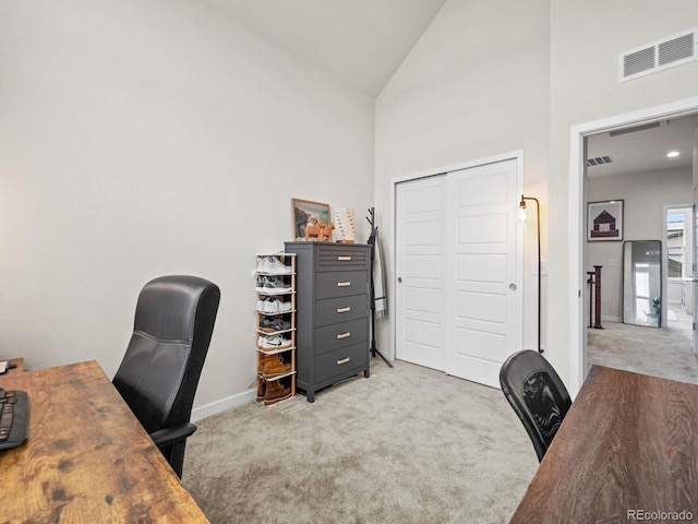 office with carpet floors, high vaulted ceiling, and visible vents