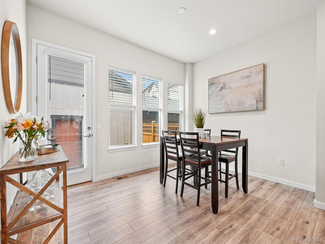 dining area featuring light wood-style flooring, baseboards, and recessed lighting